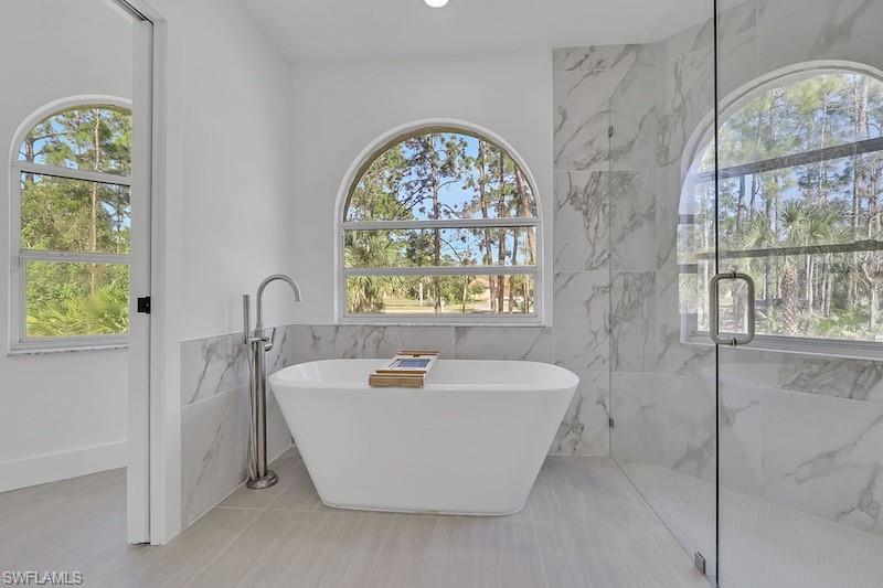 440 33rd Avenue Northeast Naples, FL 34120 - Photo 16 of 34 a white bath tub sitting next to a window