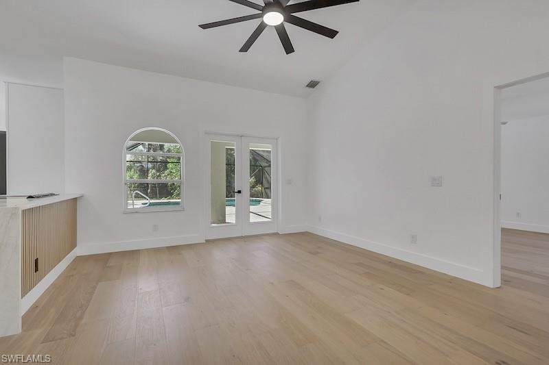 440 33rd Avenue Northeast Naples, FL 34120 - Photo 18 of 34 a view of an empty room with a window and wooden floor