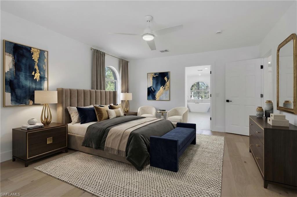 440 33rd Avenue Northeast Naples, FL 34120 - Photo 2 of 34 a spacious bedroom with a bed a couch and dresser