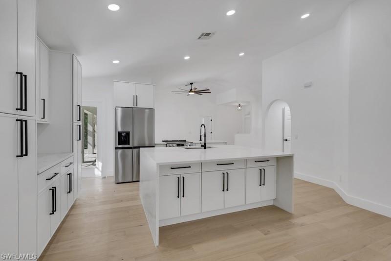 440 33rd Avenue Northeast Naples, FL 34120 - Photo 22 of 34 a large kitchen with stainless steel appliances a large counter top a sink and a refrigerator