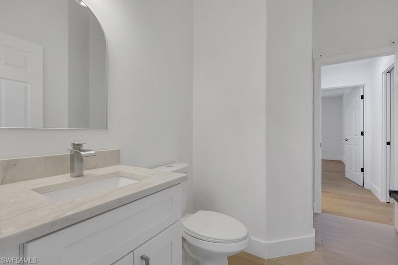 440 33rd Avenue Northeast Naples, FL 34120 - Photo 25 of 34 a bathroom with a sink a toilet and vanity