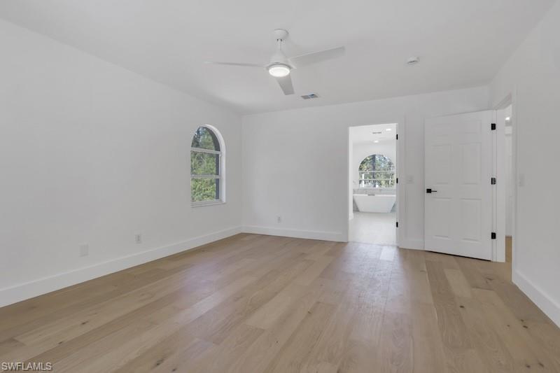 440 33rd Avenue Northeast Naples, FL 34120 - Photo 3 of 34 an empty room with wooden floor and windows