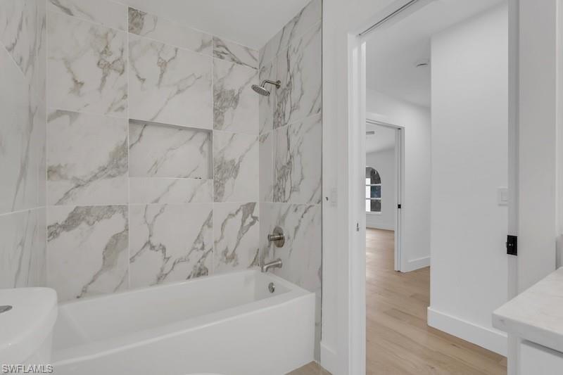 440 33rd Avenue Northeast Naples, FL 34120 - Photo 31 of 34 a bathroom with a bathtub and shower