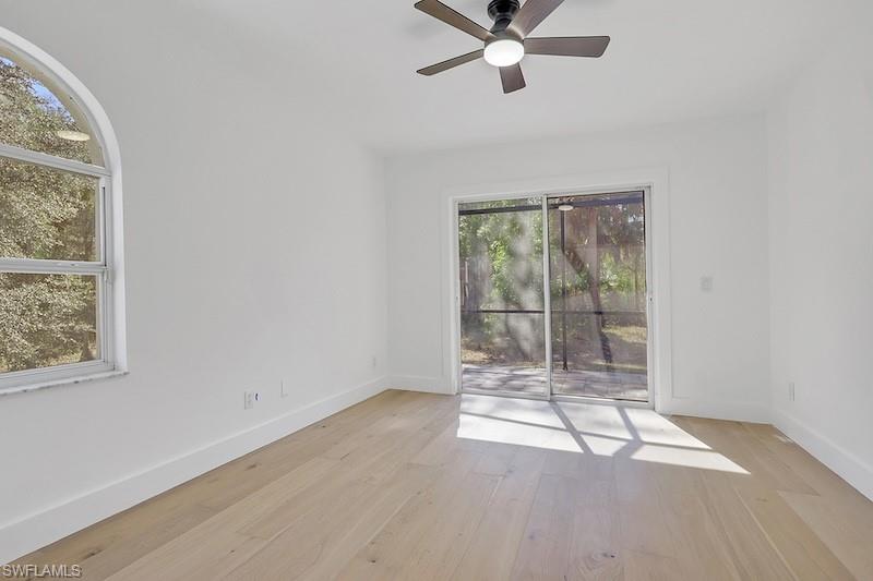 440 33rd Avenue Northeast Naples, FL 34120 - Photo 32 of 34 an empty room with wooden floor and windows