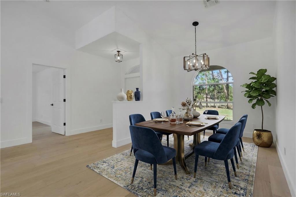 440 33rd Avenue Northeast Naples, FL 34120 - Photo 7 of 34 a view of a dining room with furniture and chandelier