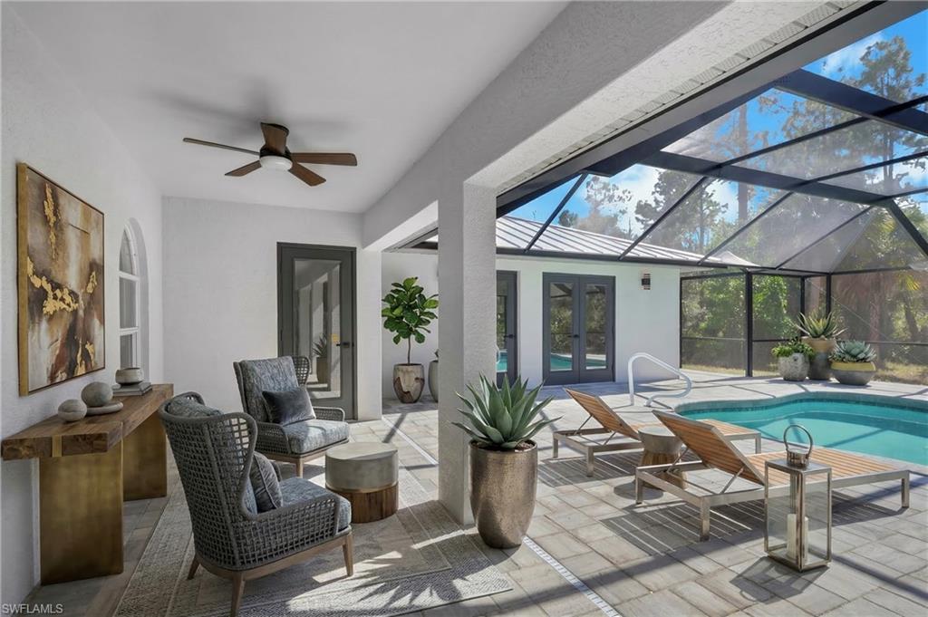440 33rd Avenue Northeast Naples, FL 34120 - Photo 10 of 34 a living room with patio furniture and a large window