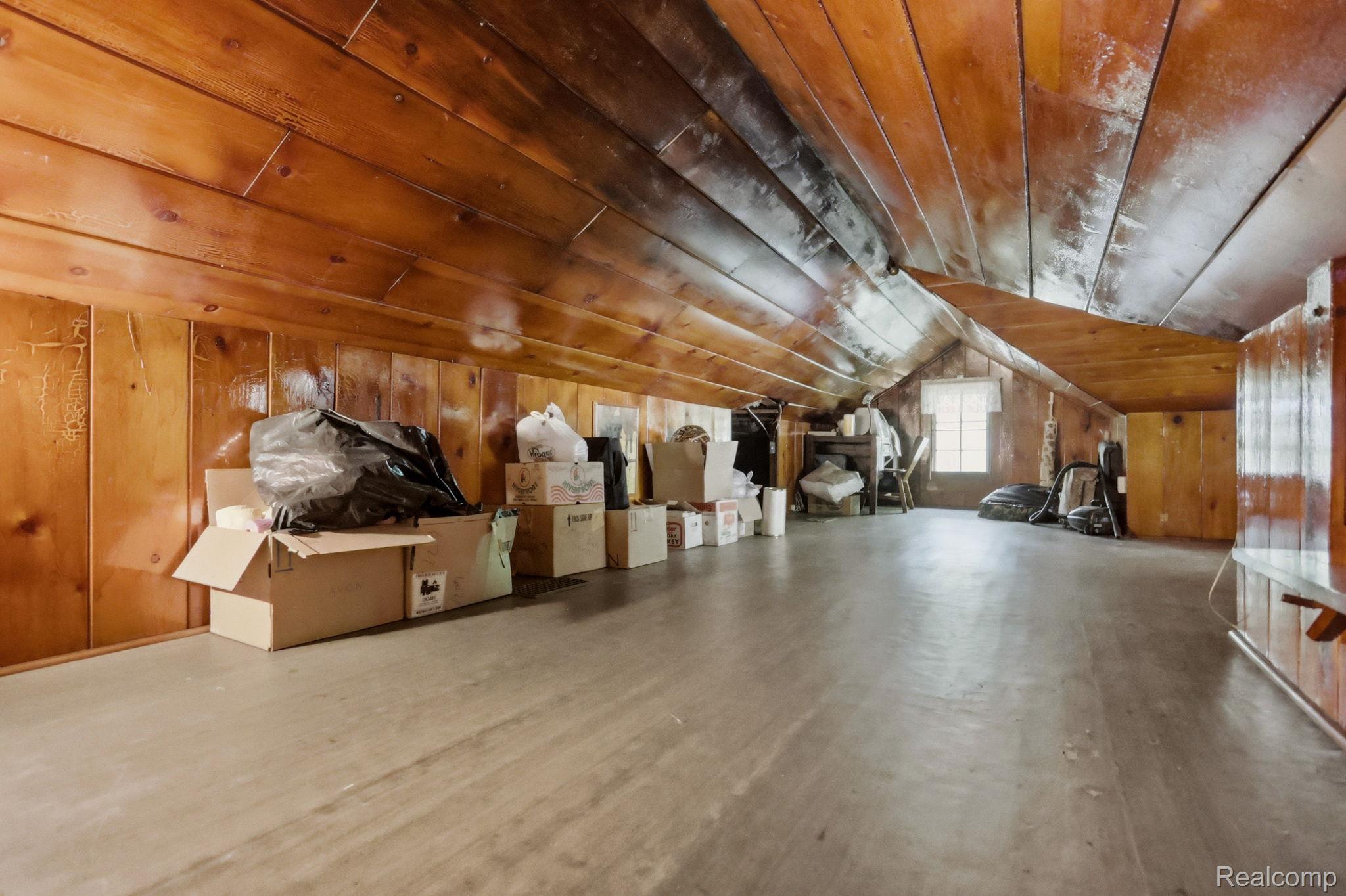 3814 South Towerline Road Bridgeport, MI 48722 - Photo 30 of 52 Spacious attic area featuring wood-paneled walls and ceiling