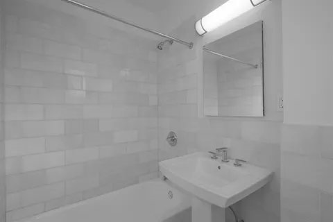 a bathroom with a sink a mirror and shower