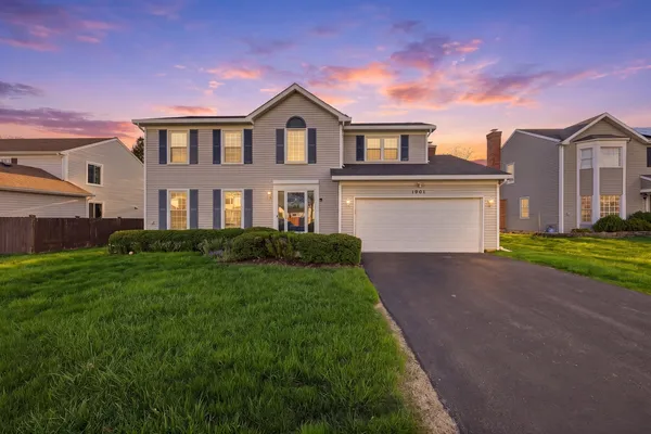 a front view of a house with a yard and garage