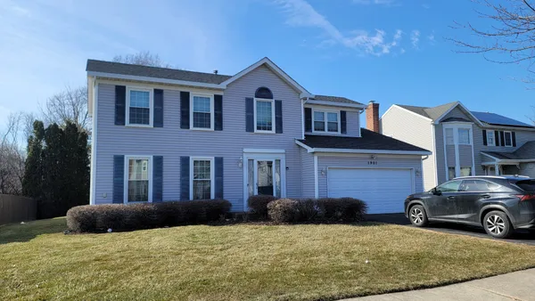 a view of a car parked in front of a brick house