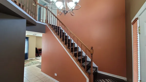 a view of entryway and hall with wooden floor