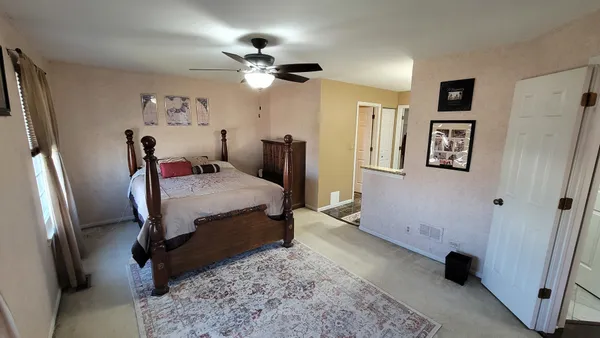 a bedroom with bed and a chandelier