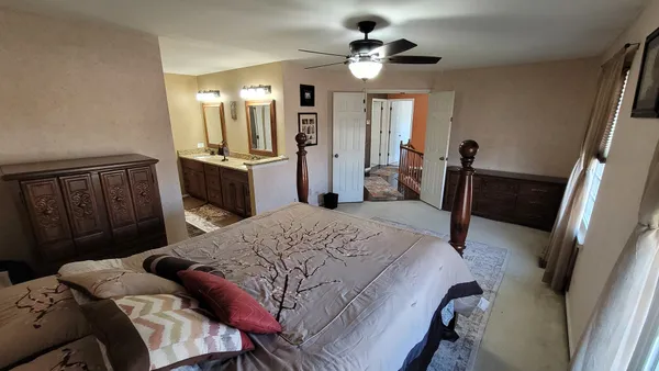 a bedroom with a bed closet and a mirror
