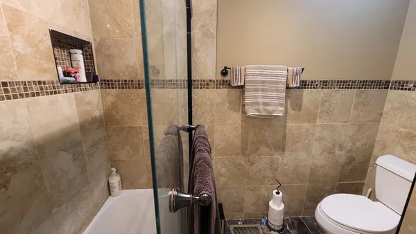 a bathroom with a toilet and a shower