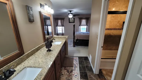 a view of living room and kitchen with wooden floor