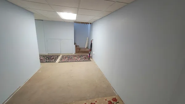 a bedroom with a bed and a refrigerator