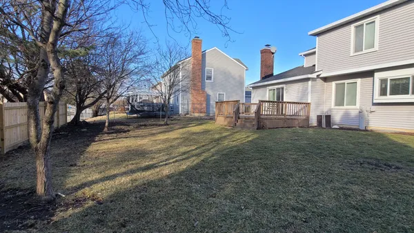 a view of a backyard with a fence