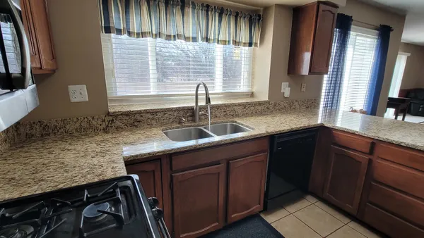 a kitchen with granite countertop a sink and a window