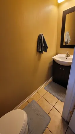 a bathroom with a toilet and a mirror