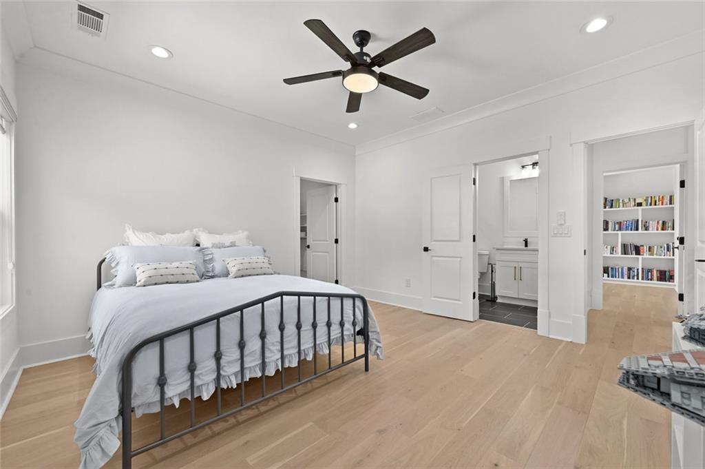 2694 Thompson Mill Road Buford, GA 30519 - Photo 50 of 70 a bedroom with a bed and a chandelier