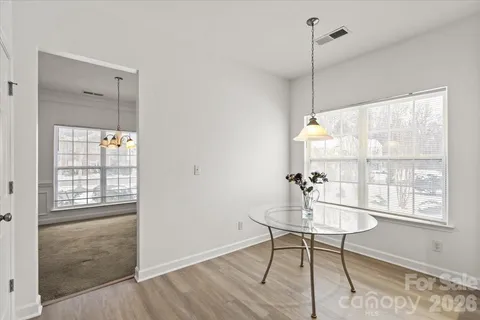 a view of an empty room with a window and fireplace