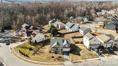 a view of a hallway with wooden floor and a chandelier