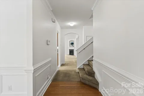 a view of a livingroom with an empty space & wooden floor