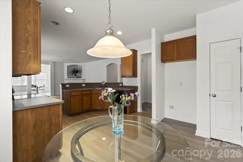 a kitchen with stainless steel appliances granite countertop sink stove top oven and cabinets