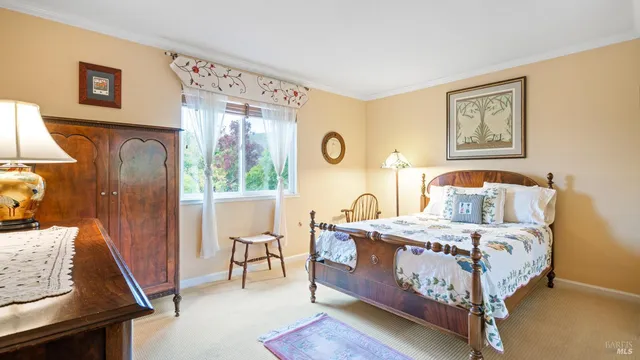 a bedroom with furniture and a window