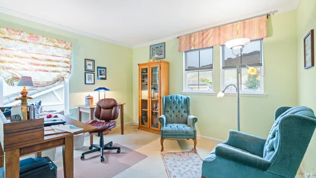 a bedroom with furniture and a chair