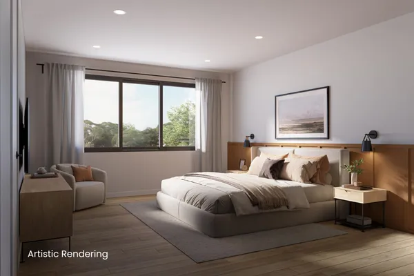a bedroom with a large bed and a large window