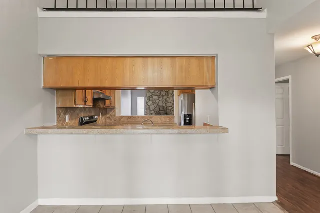 a view of a kitchen with a sink and a window