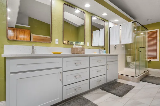 a bathroom with a double vanity sink mirror and double