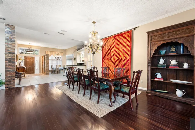 a dining room with furniture and wooden floor