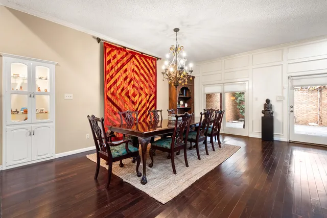a view of a dining room with furniture wooden floor and chandelier