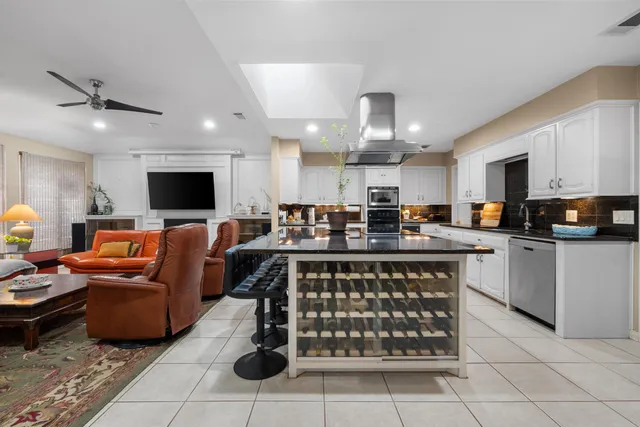 a kitchen with a sink a counter top space cabinets and stainless steel appliances