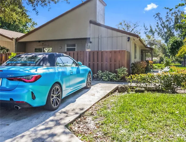a front view of a house with a garden and parking space