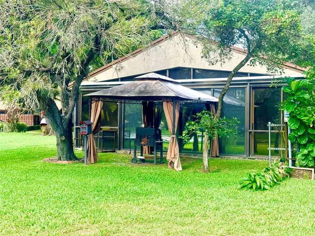 a view of a chair and table under the umbrella