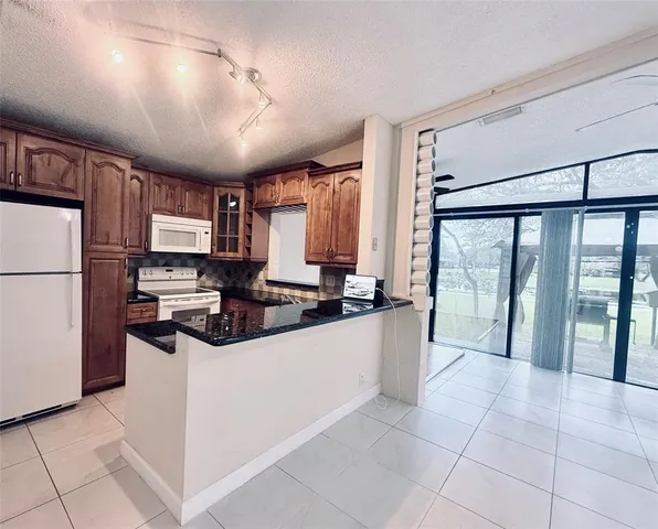 a large kitchen with a large window and stainless steel appliances