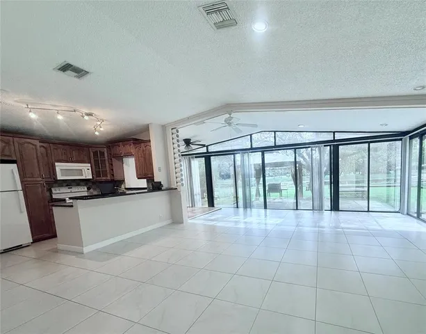 a large white kitchen with a large window