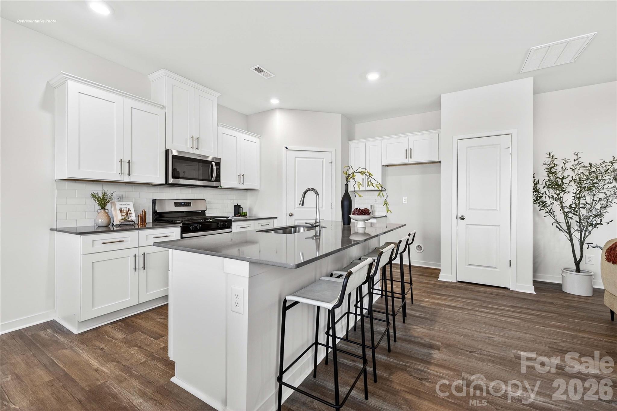 1375 Mammoth Road Hickory, NC 28602 - Photo 5 of 20 a kitchen with kitchen island granite countertop a sink a stove a refrigerator cabinets and a dining table