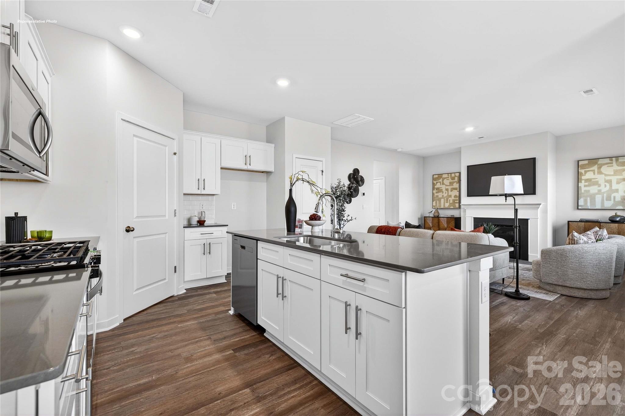 1375 Mammoth Road Hickory, NC 28602 - Photo 7 of 20 a kitchen with white cabinets sink and stove
