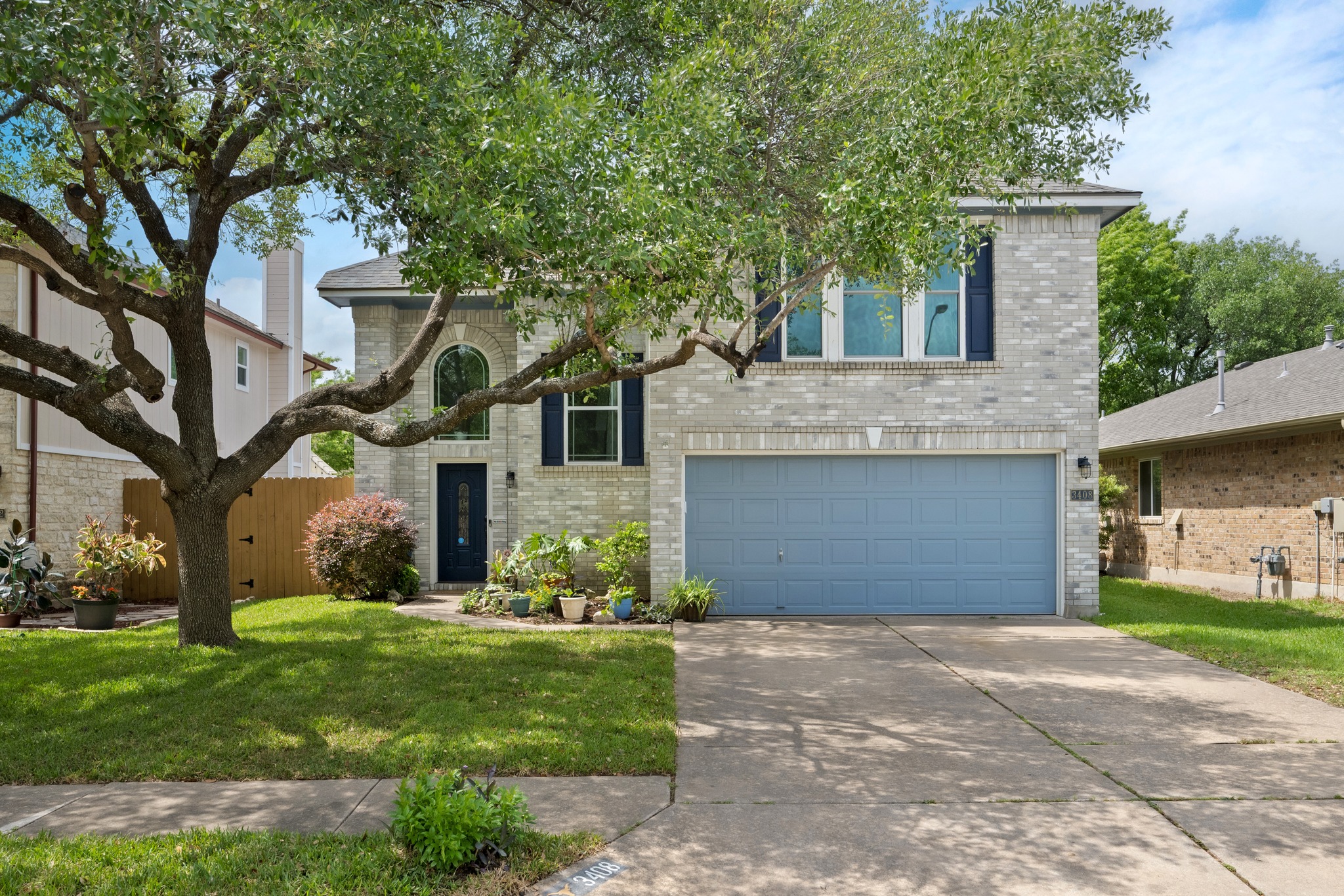 a front view of a house with a yard and trees