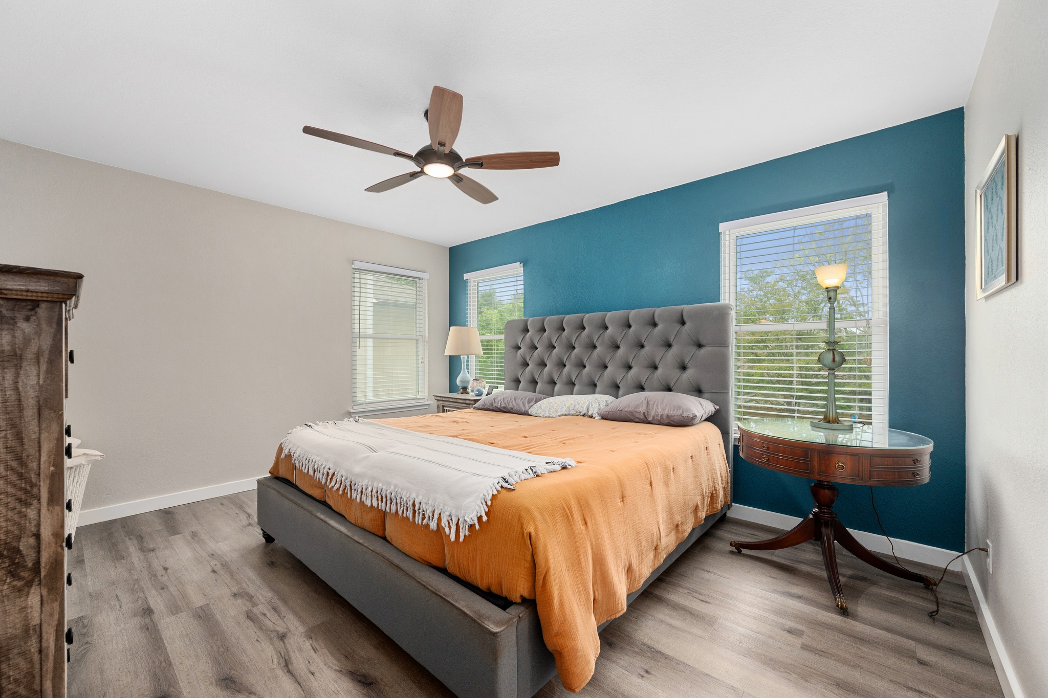 3408 Ruby Red Drive Austin, TX 78728 - Photo 13 of 26 a large bed sitting in a bedroom next to a window and a chandelier