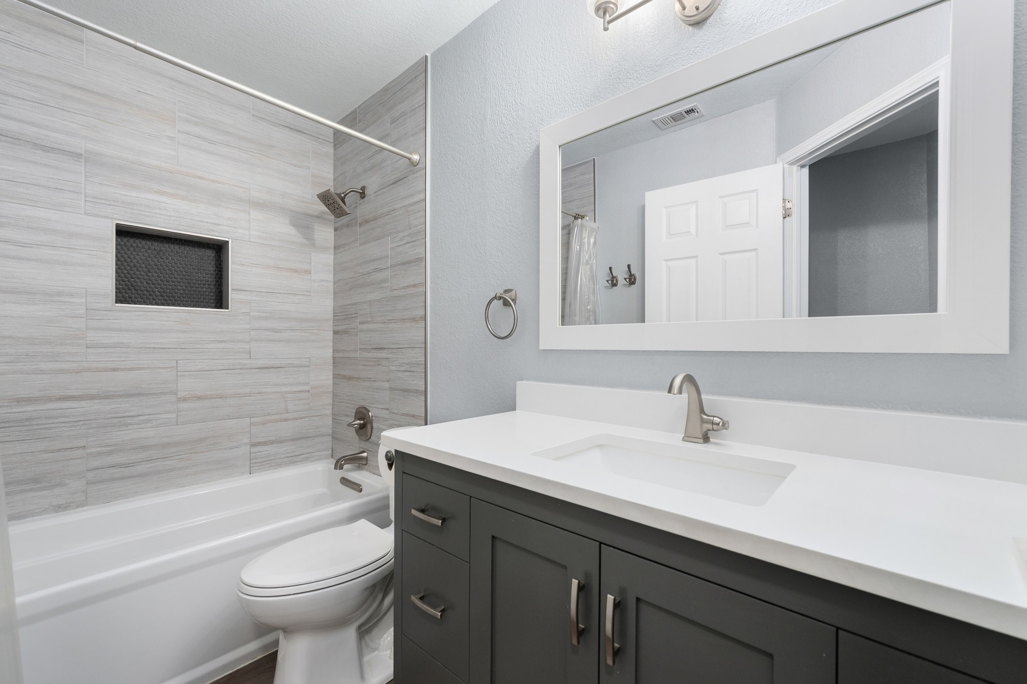 3408 Ruby Red Drive Austin, TX 78728 - Photo 20 of 26 a bathroom with a sink toilet a mirror and shower