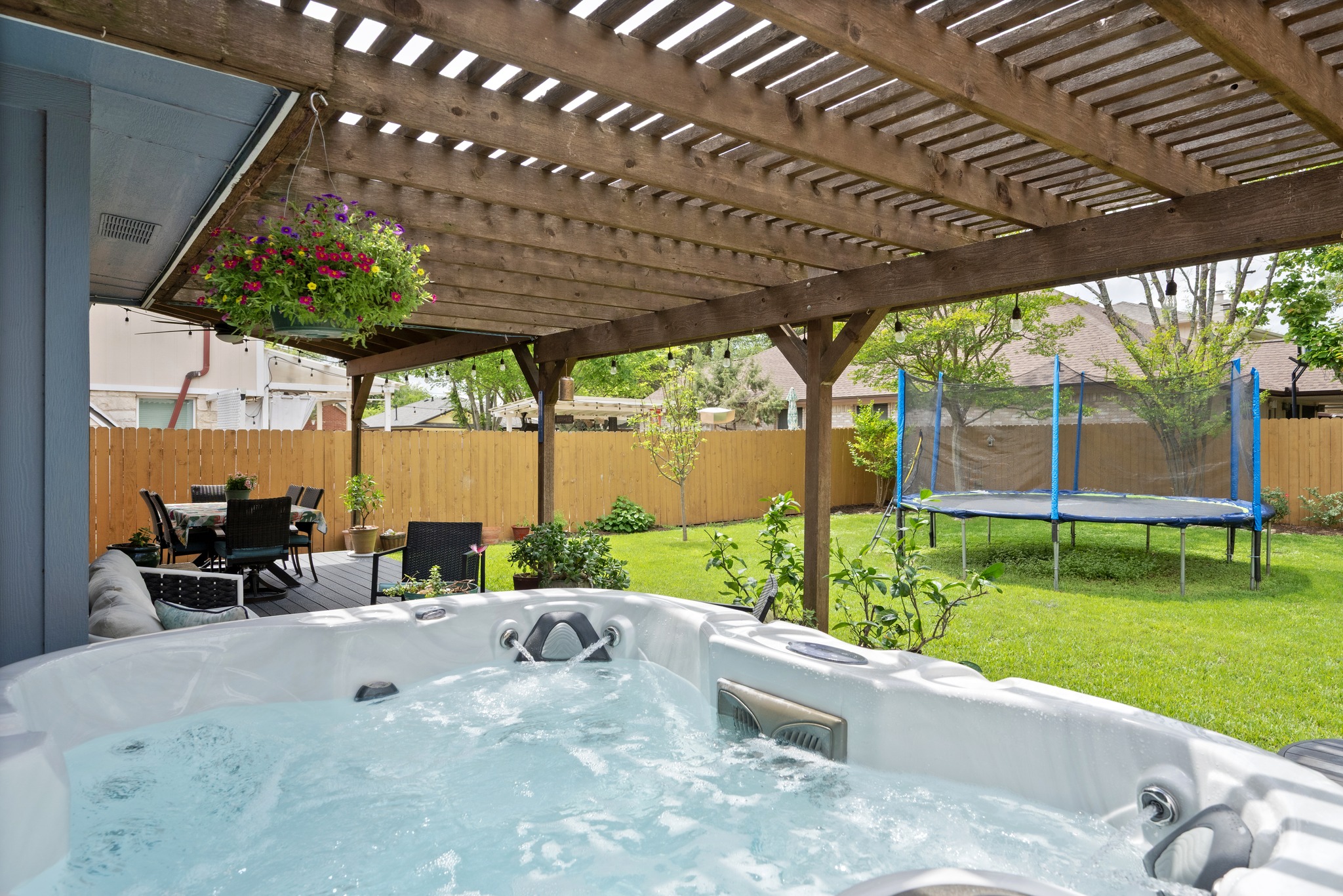 3408 Ruby Red Drive Austin, TX 78728 - Photo 23 of 26 a view of a patio with a table and chairs under an umbrella with a big yard