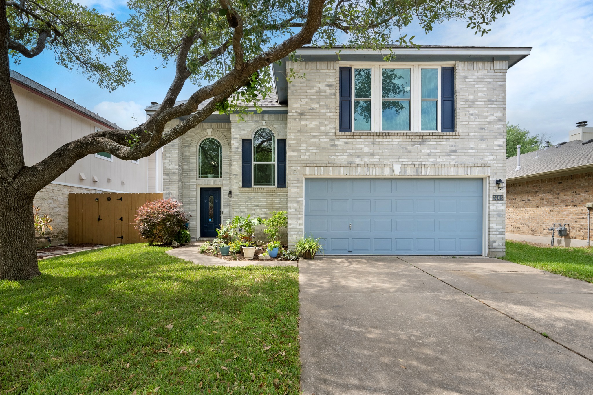 3408 Ruby Red Drive Austin, TX 78728 - Photo 3 of 26 a front view of a house with a yard and garage