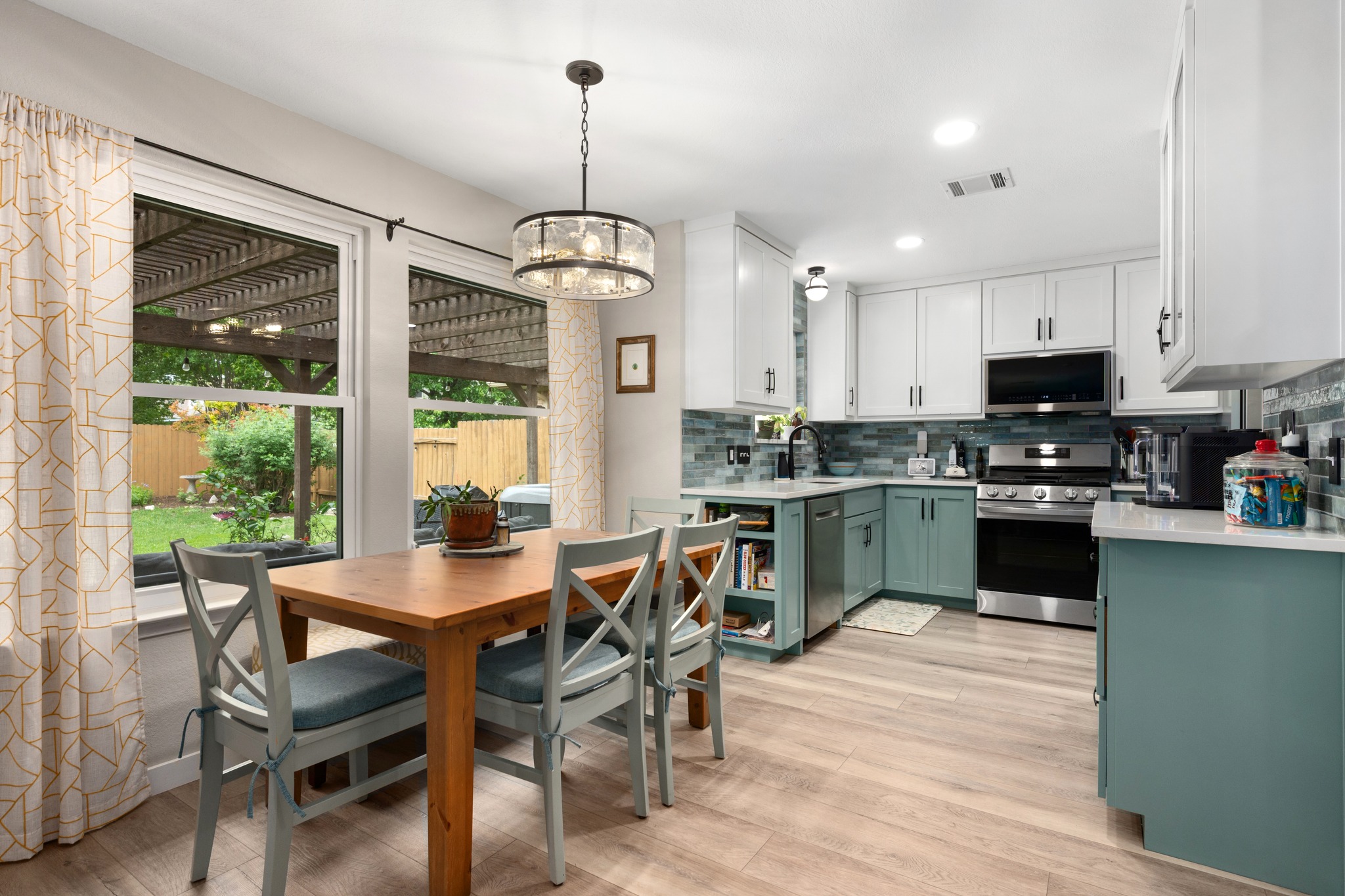 3408 Ruby Red Drive Austin, TX 78728 - Photo 7 of 26 a kitchen with a dining table chairs wooden floor and appliances