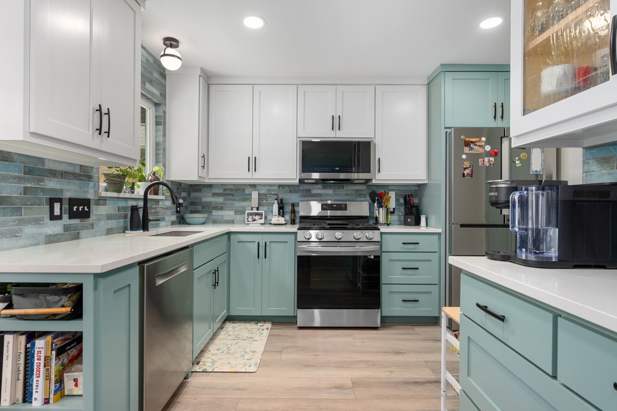 3408 Ruby Red Drive Austin, TX 78728 - Photo 10 of 26 a kitchen with stainless steel appliances granite countertop a stove top oven a sink dishwasher and a microwave oven with white cabinets
