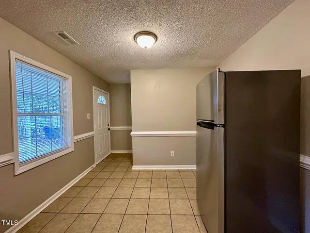 a view of a livingroom with an empty space and window
